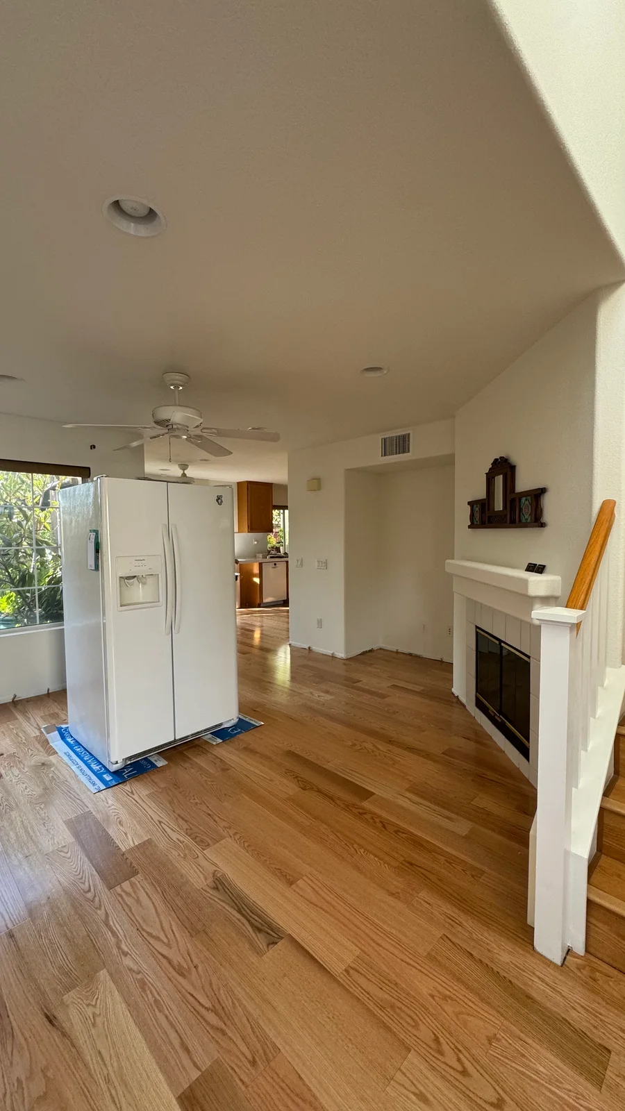 Finished wood-tone floor and kitchen