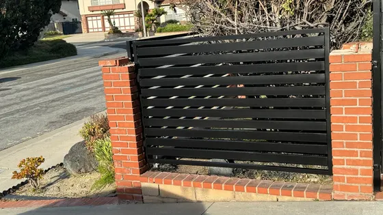 Horizontal slat fence and masonry posts