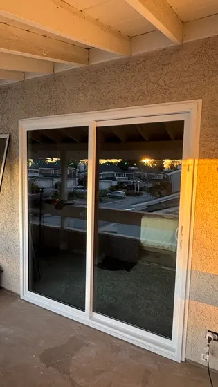 Sliding door under patio cover