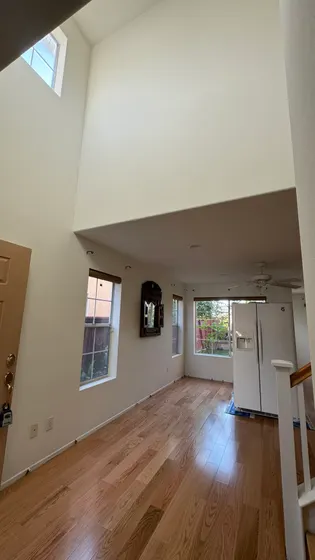 Finished wood-tone floor through doorway