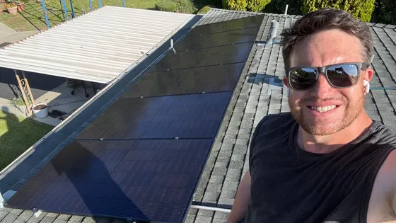 Person beside clean solar panels