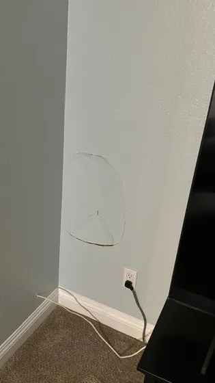 A man is looking at himself in a bathroom mirror.