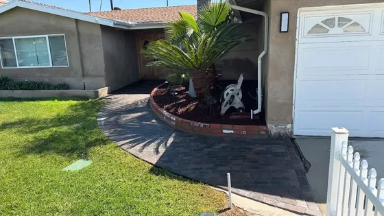 A house with a white garage door and a bench in front of it.